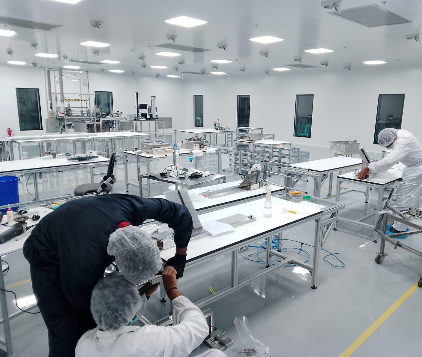 FLECS engineers working with a client team inside a cleanroom